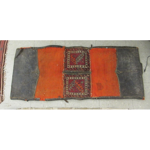 123 - Three rugs: to include a (probably) North African example, decorated with repeating designs in brigh... 