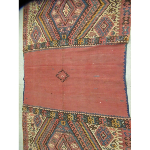 123 - Three rugs: to include a (probably) North African example, decorated with repeating designs in brigh... 