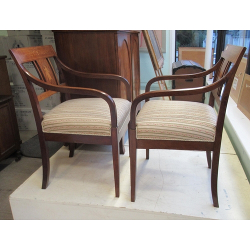 127 - A pair of Edwardian string inlaid and marquetry mahogany framed open arm chairs, the later floral pa... 