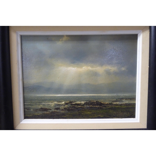 128 - 20thC British School - a seascape with sunlight breaking through clouds  oil on board  bea... 