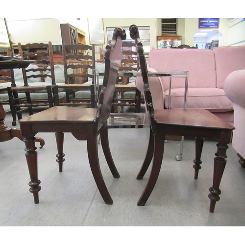 137 - A pair of late Victorian mahogany framed hall chairs with C-scroll carved solid backs and seats, rai... 