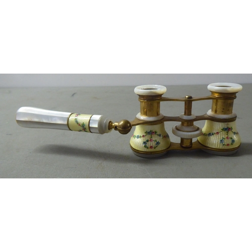 140 - A pair of lacquered gilt metal mother-of-pearl and painted enamel opera glasses, on an offset handle... 