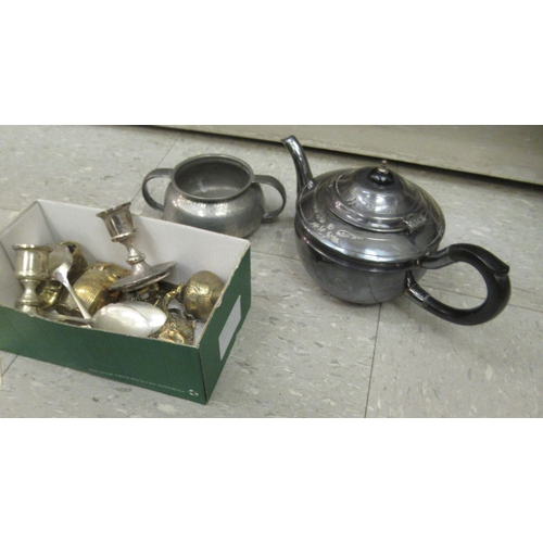 15 - A mixed lot: to include an Arts & Crafts period three piece spot hammered pewter tea set; a pair... 