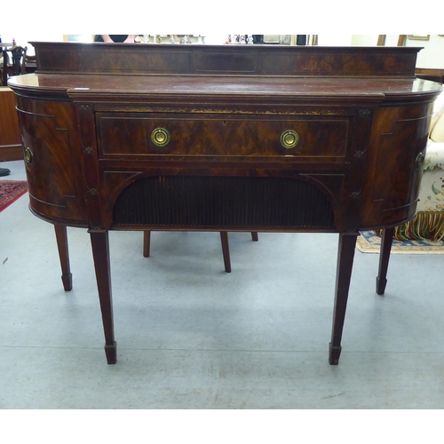 151 - An Edwardian mahogany breakfront sideboard with two drawers and two doors, raised on square, tapered... 