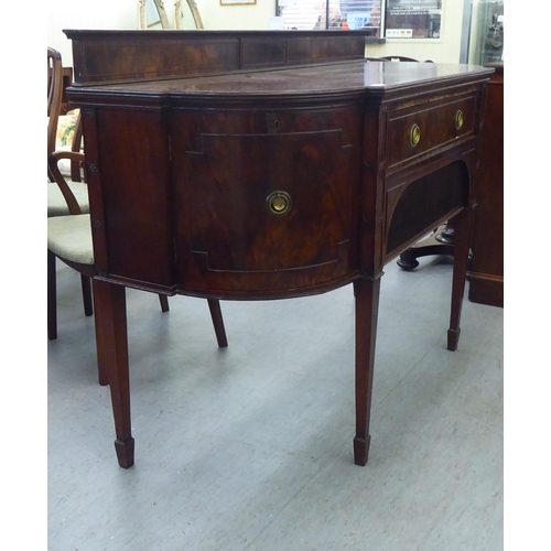 151 - An Edwardian mahogany breakfront sideboard with two drawers and two doors, raised on square, tapered... 