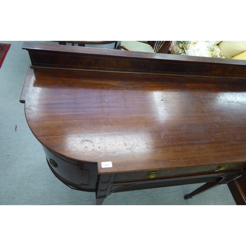 151 - An Edwardian mahogany breakfront sideboard with two drawers and two doors, raised on square, tapered... 