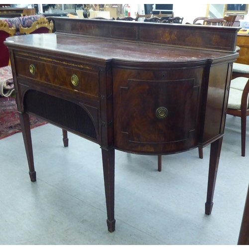 151 - An Edwardian mahogany breakfront sideboard with two drawers and two doors, raised on square, tapered... 