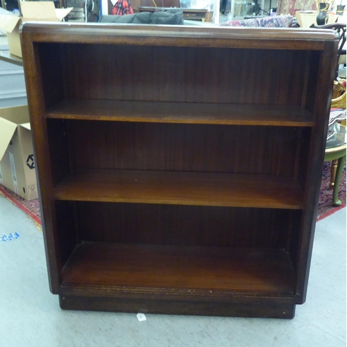 169 - A 20thC mahogany open front two tier bookcase, on a plinth  40