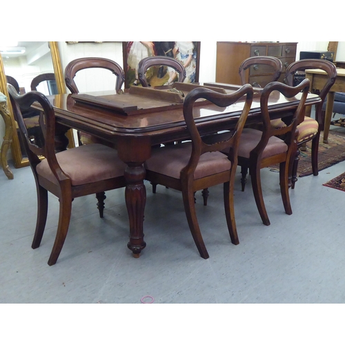 177 - A late Victorian mahogany extending dining table, the top with round corners, raised on bulbous turn... 