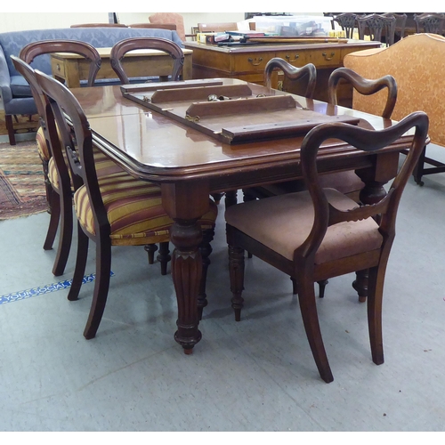 177 - A late Victorian mahogany extending dining table, the top with round corners, raised on bulbous turn... 