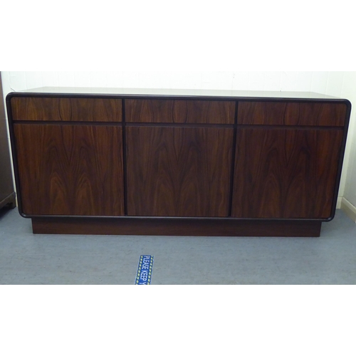 179 - A modern rosewood effect sideboard with three frieze drawers, over three doors, on a plinth  33