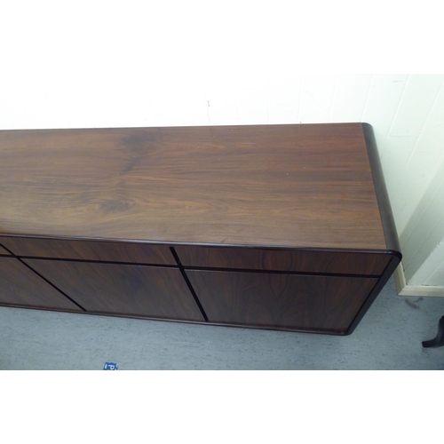 179 - A modern rosewood effect sideboard with three frieze drawers, over three doors, on a plinth  33