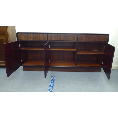 179 - A modern rosewood effect sideboard with three frieze drawers, over three doors, on a plinth  33