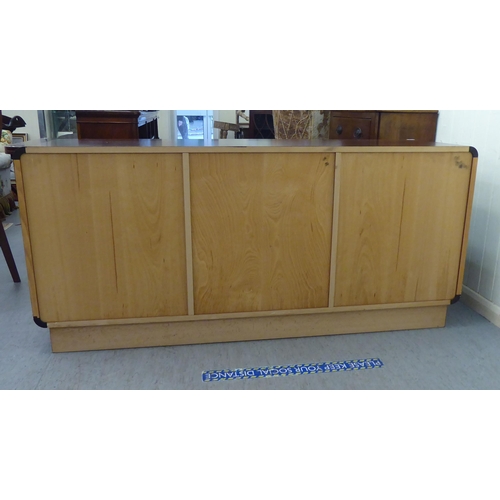 179 - A modern rosewood effect sideboard with three frieze drawers, over three doors, on a plinth  33