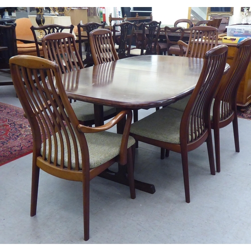 180 - A modern rosewood effect twin pedestal dining table, the top with round corners, raised on splayed s... 