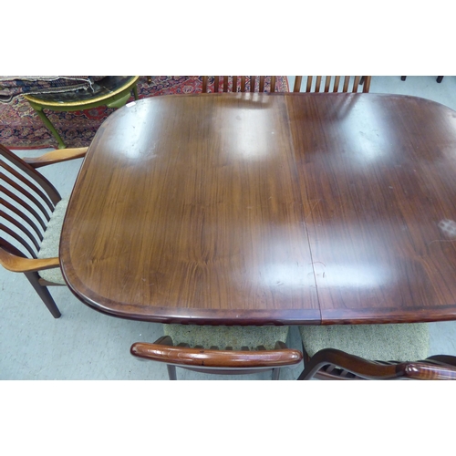 180 - A modern rosewood effect twin pedestal dining table, the top with round corners, raised on splayed s... 