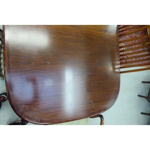 180 - A modern rosewood effect twin pedestal dining table, the top with round corners, raised on splayed s... 