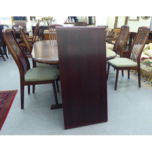 180 - A modern rosewood effect twin pedestal dining table, the top with round corners, raised on splayed s... 