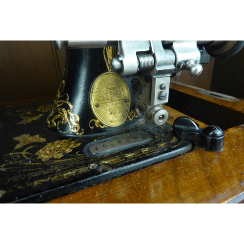 182 - A late Victorian Frister & Rossmann manual sewing machine  model no.1058986  cased&nbs... 