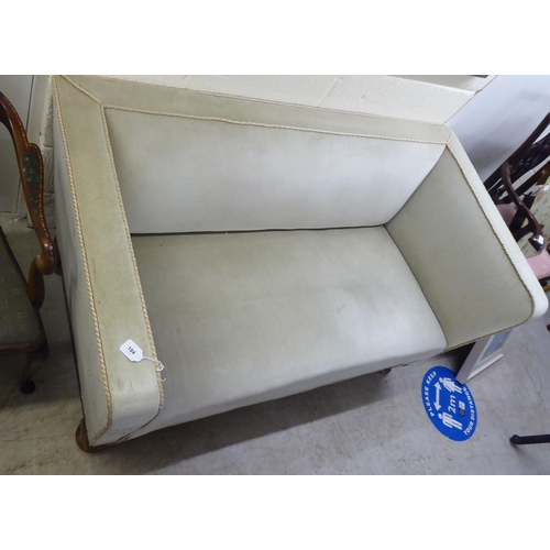 184 - A 1920s/1930s and later fabric upholstered two person settee with a level back and arms, raised on a... 