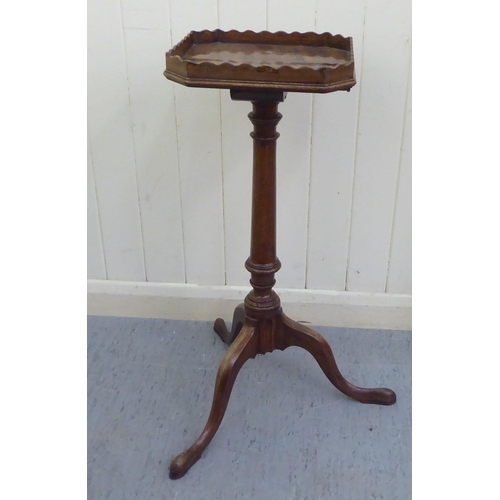 186 - A 19thC style mahogany wine table with a galleried tray-top and later candle slide, over a ring turn... 