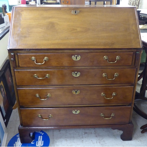 187 - A George III mahogany bureau, the fall flap over four graduated long drawers, raised on bracket feet... 