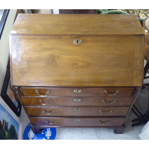 187 - A George III mahogany bureau, the fall flap over four graduated long drawers, raised on bracket feet... 