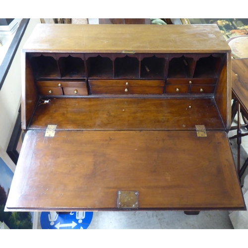 187 - A George III mahogany bureau, the fall flap over four graduated long drawers, raised on bracket feet... 