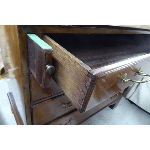 187 - A George III mahogany bureau, the fall flap over four graduated long drawers, raised on bracket feet... 