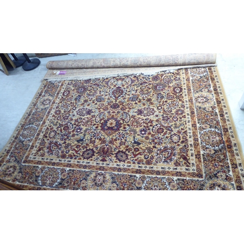 198 - A Persian inspired machine made rug, profusely decorated with floral designs, on a multi-coloured gr... 