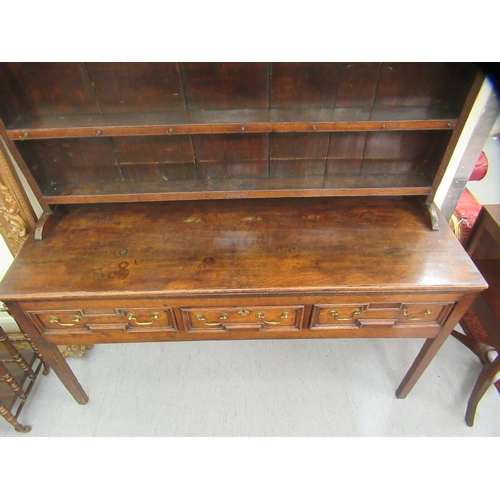 200 - A George III stained oak dresser, the superstructure with three open plate racks, over three inline ... 