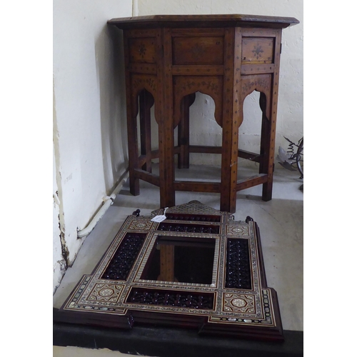 201 - An early/mid 20thC Indian brass inlaid fruitwood octagonal occasional table, on a folding underframe... 