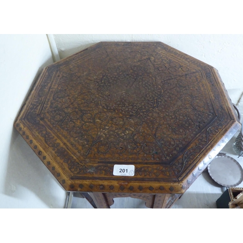 201 - An early/mid 20thC Indian brass inlaid fruitwood octagonal occasional table, on a folding underframe... 