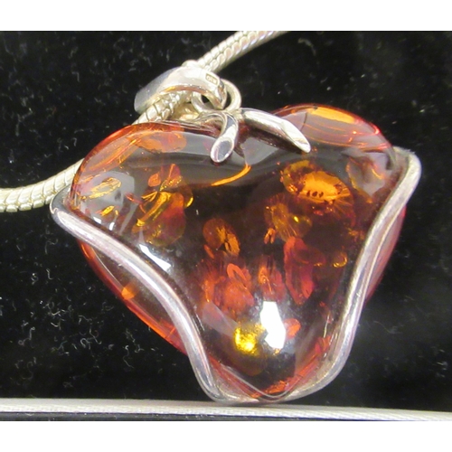 211 - A Pandora white metal necklace with a heart shaped, amber coloured stone