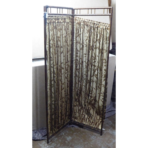 236 - A 20thC painted bamboo effect framed two-fold dressing room screen with fabric curtains  66