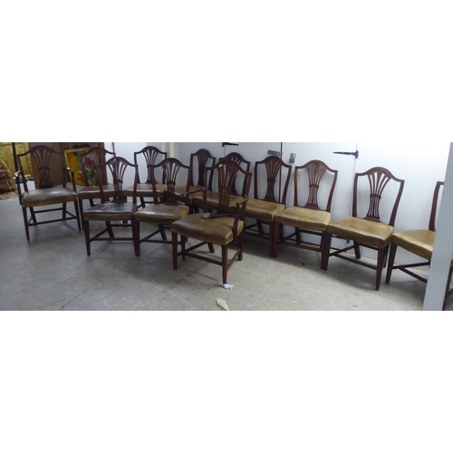 238 - A set of twelve early 20thC Hepplewhite design, mahogany framed dining chairs, the stud upholstered ... 