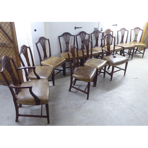 238 - A set of twelve early 20thC Hepplewhite design, mahogany framed dining chairs, the stud upholstered ... 