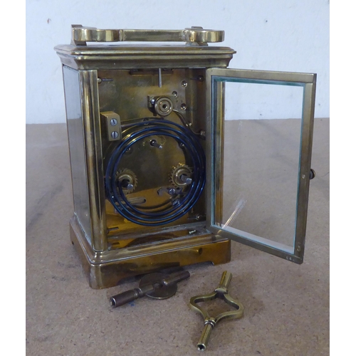 242 - An early 20thC lacquered brass and glazed carriage timepiece; the movement faced by an enamel Arabic... 