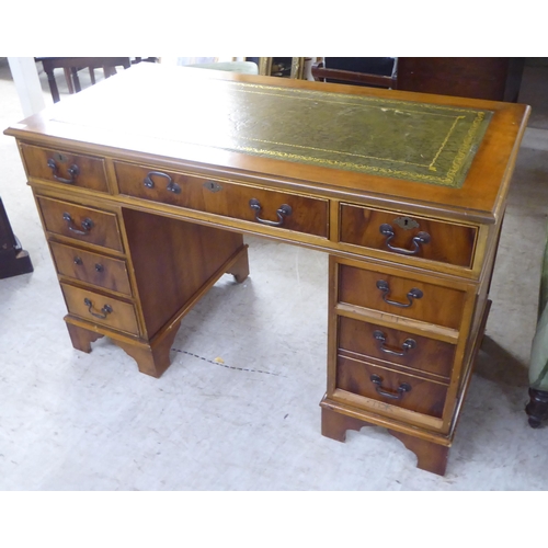 243 - A modern mahogany eight drawer, twin pedestal desk, raised on bracket feet  30