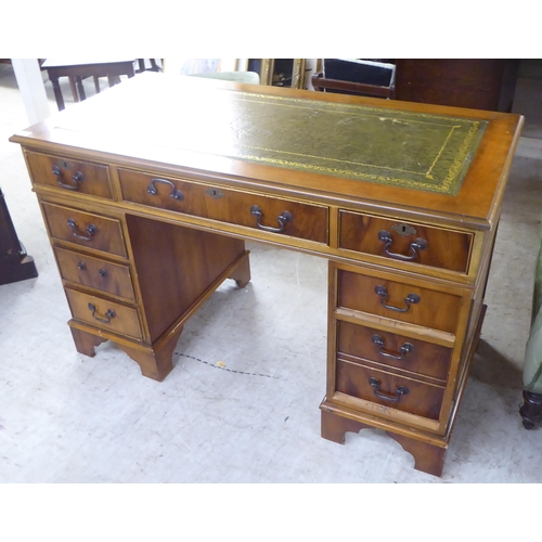 243 - A modern mahogany eight drawer, twin pedestal desk, raised on bracket feet  30