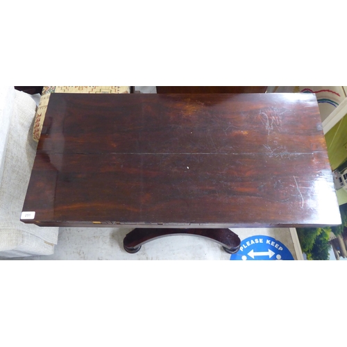 251 - A William IV rosewood card table, the rotating foldover top raised on a carved pedestal and splayed ... 