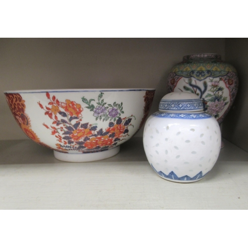 260 - Oriental ceramics: to include a mid 20thC Chinese porcelain teapot with green glazed floral decorati... 