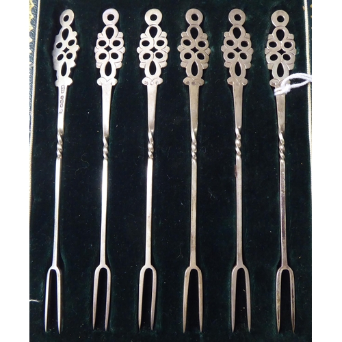 27 - A set of six silver pickle forks with decoratively pierced terminals  Sheffield 1925  case... 