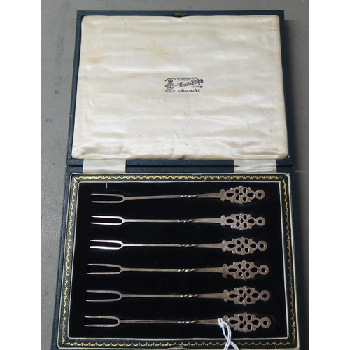 27 - A set of six silver pickle forks with decoratively pierced terminals  Sheffield 1925  case... 