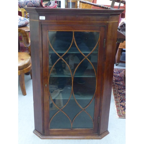 277 - A 19thC string inlaid mahogany hanging display cabinet with canted sides and a glazed, panelled door... 