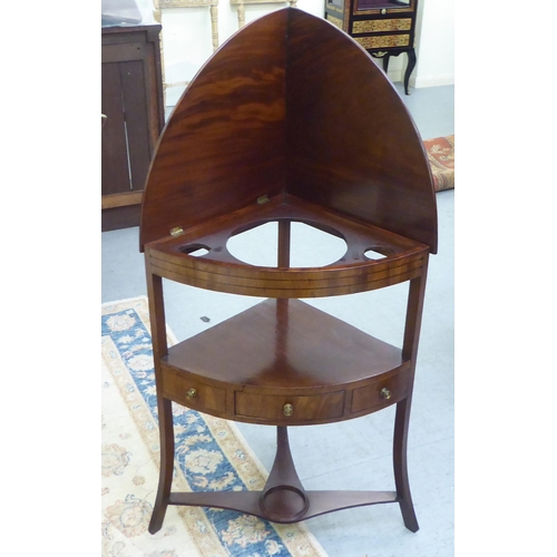 287 - An early 19thC mahogany and ebony string inlaid, freestanding, quadrant washstand, the rising, quart... 