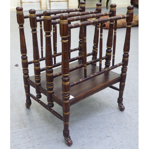 292 - A 19thC simulated rosewood and gilded Canterbury with four spindled divisions, raised on turned legs... 