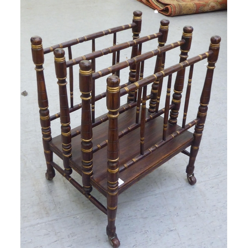 292 - A 19thC simulated rosewood and gilded Canterbury with four spindled divisions, raised on turned legs... 