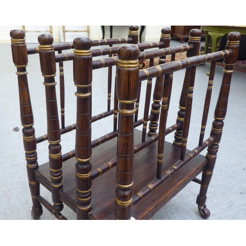 292 - A 19thC simulated rosewood and gilded Canterbury with four spindled divisions, raised on turned legs... 