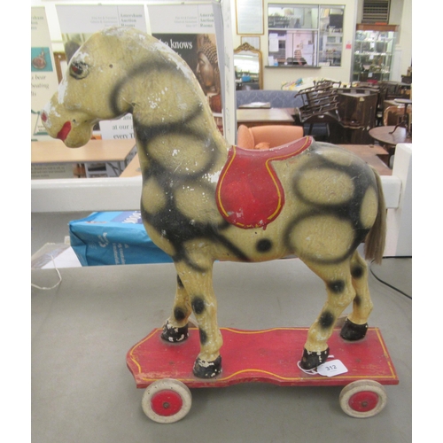 312 - A vintage painted pull-along toy dappled horse, on wheels  18